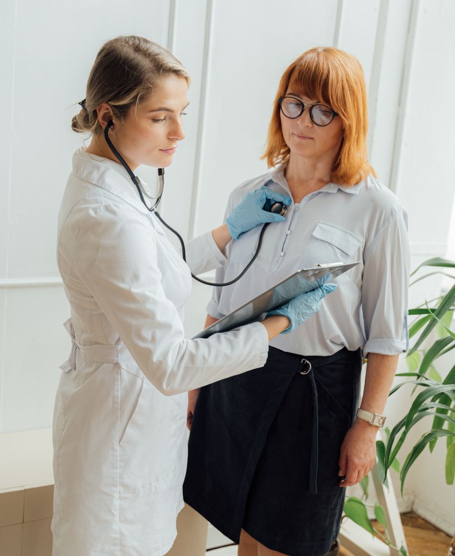 Cardiologist listening to a patient's heartbeat with a stethoscope