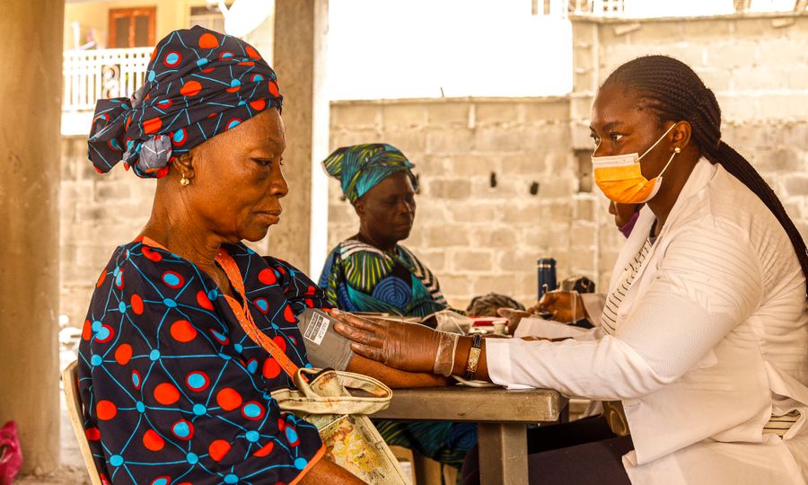 Doctor checking a patient's blood pressure during a preventive checkup